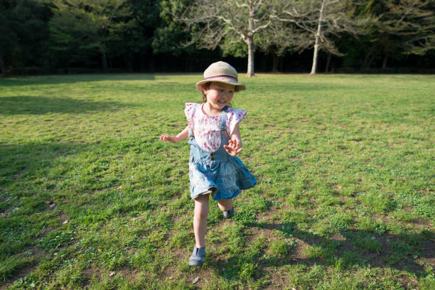 istock Little girl running in the meadow 936206916