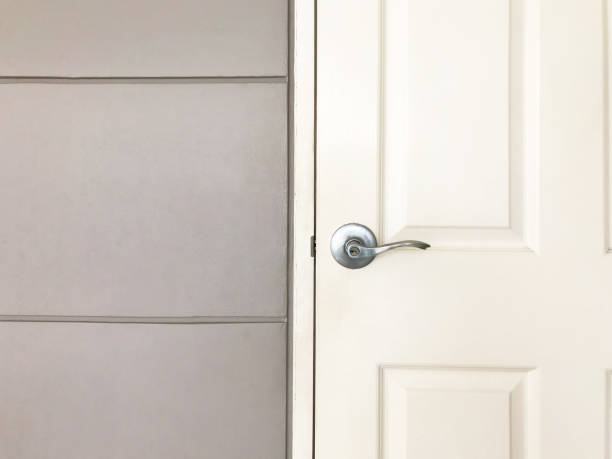 istock White close wooden door and gray wall 936206986