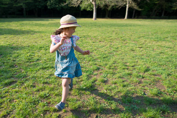 istock Little girl running in the meadow 936207122