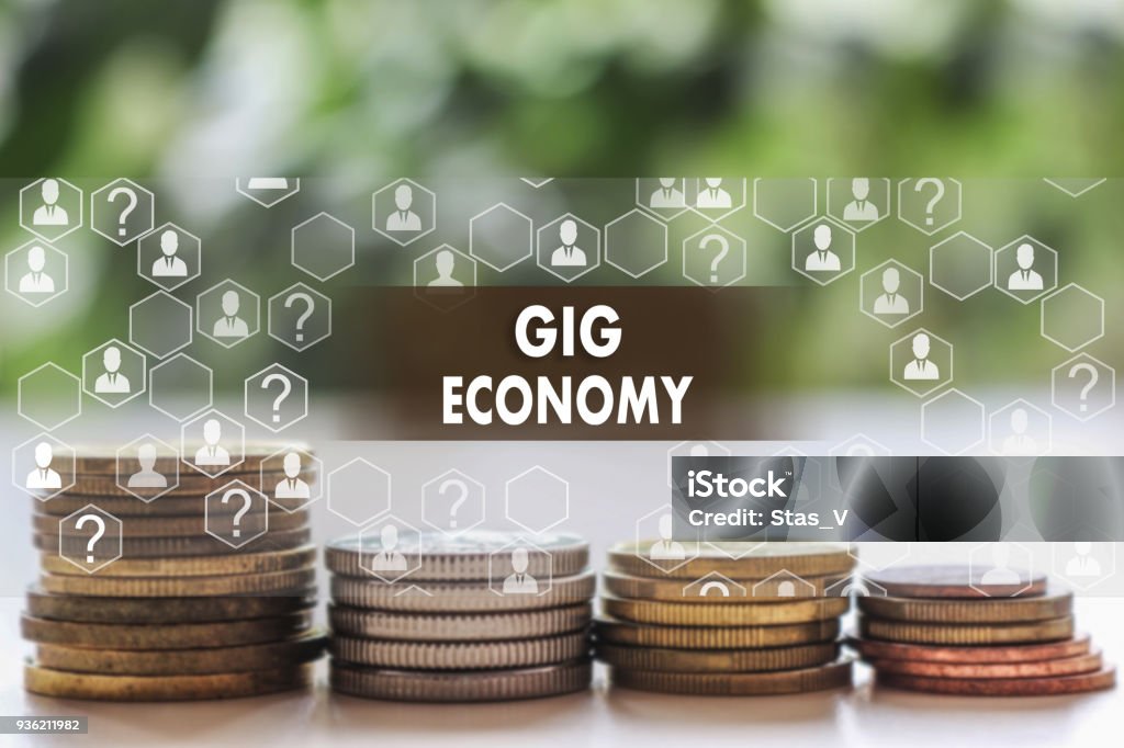 GIG ECONOMY on the touch screen with a  blur financial background .The concept GIG ECONOMY Gig Economy Stock Photo