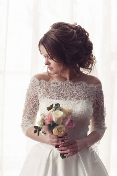istock portrait of the bride on the window background 936215438