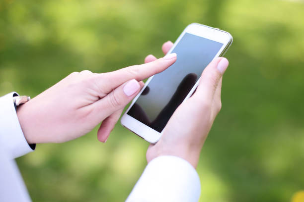 istock Woman using mobile smart phone in the park 936221926
