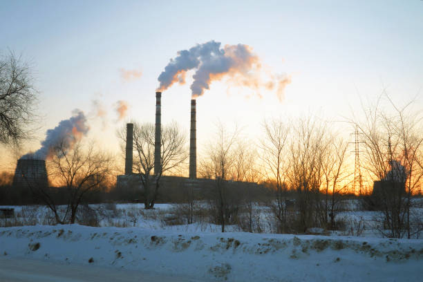 istock Smoke from factory chimneys on sunset sky 936223268