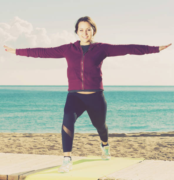 istock girl exercising on exercise mat outdoor 936230206