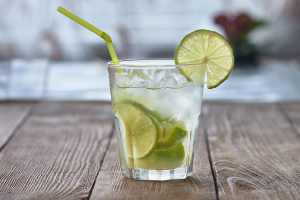 istock Caipirinha with ice and lime on a wooden table. Summer soft drink. 936237680
