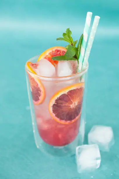 Cold cocktail with fresh bloodoranges and mint leaves