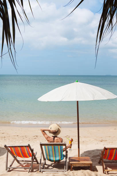 istock Woman on a tropical beach 936257502