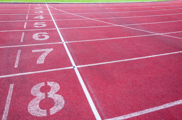 istock Numbers starting point on red running track,running track and green grass 936267988
