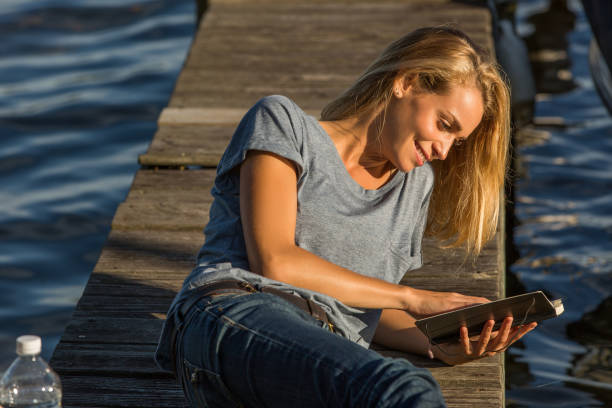 istock woman relaxing on pontoon 936272896