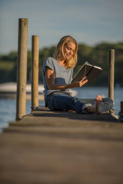istock woman relaxing on pontoon 936272940