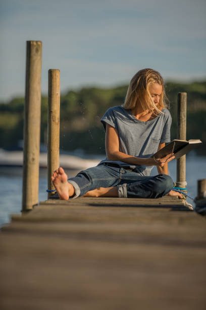 istock woman relaxing on pontoon 936272948