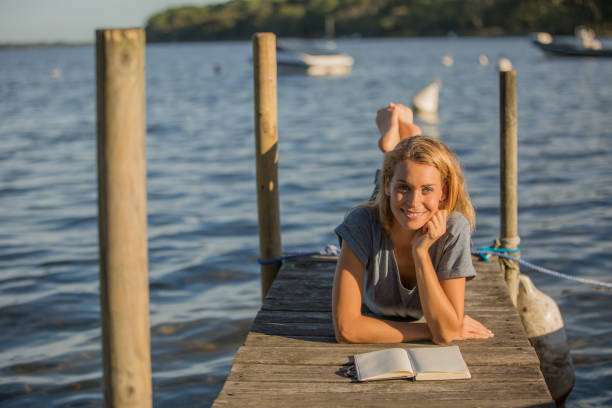istock beautiful woman relaxing on pontoon 936272984