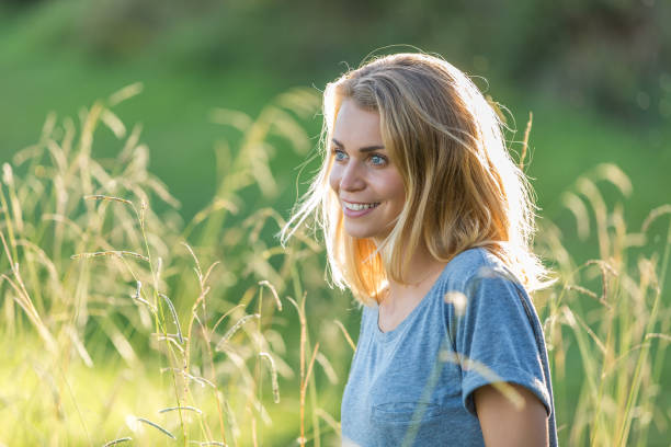 istock BEAUTIFUL YOUNG WOMAN IN field sunset 936273116