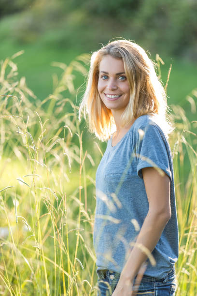 istock BEAUTIFUL YOUNG WOMAN IN field sunset 936273122
