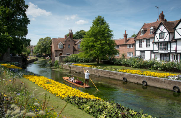 Gardens of Canterbury, Kentcape Canterbury, Kent, United Kingdom - 7 July 2017:Tourist  people taking a romantic boat ride in the canal of the river stour at the beautiful Chartham gardens in the center of the city of  Canterbury in Kent, United Kingdom. canterbury england stock pictures, royalty-free photos & images