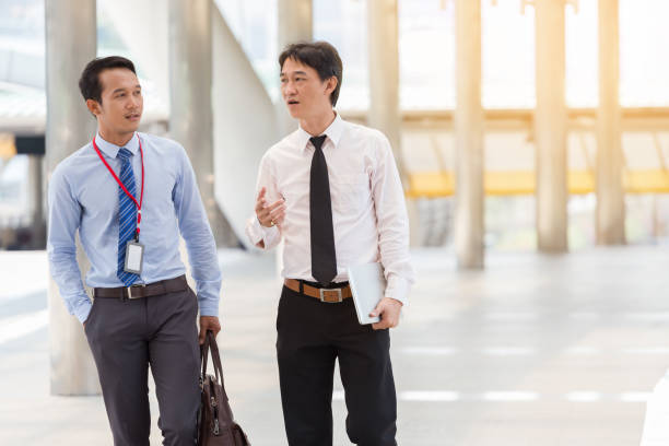 istock Two businessman Walking and talking in the city. 936276082