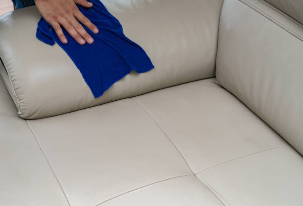 istock cleaning leather sofa with towel at home 936276410