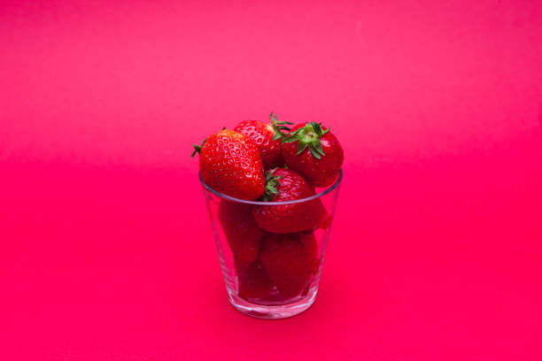 istock Strawberries in a glass on red bakcground 936277568