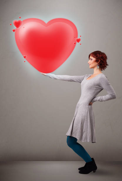 istock Young lady holding lovely 3d red heart 936277750