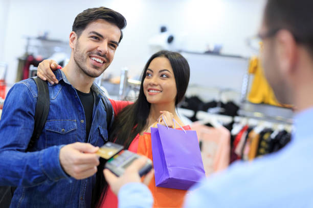 istock Couple shopping in store, using contactless payment 936279626