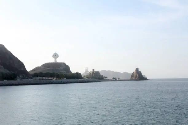Photo of Muscat Skyline with a traditional arabic Dhow anchored at the port