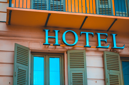 white hotel letters on orange facade