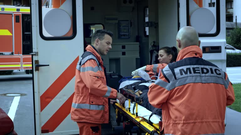 Paramedics loading the injured person into the ambulance