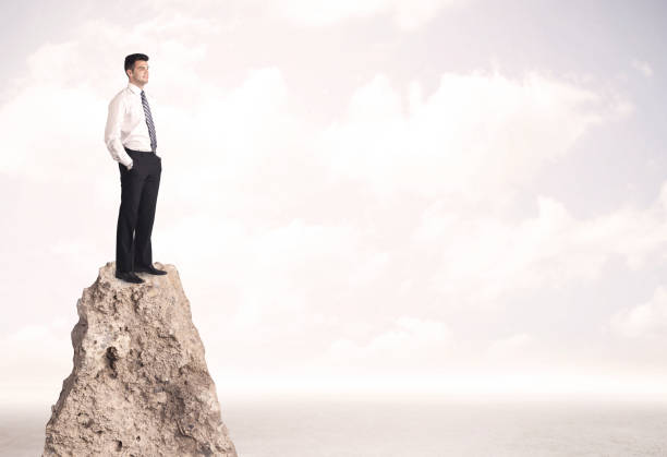 istock Happy businessman standing on cliff 936281930