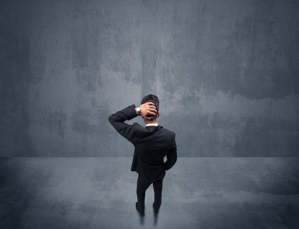 istock Businessman standing in front of urban wall 936282300