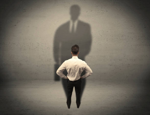 istock Businessman looking at big shadow concept 936282338