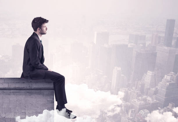 istock Sales person sitting on building edge in city 936282904