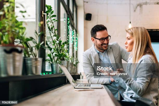 Side View Of Two Young Business People Having A Successful Meeting At Restaurant Stock Photo - Download Image Now