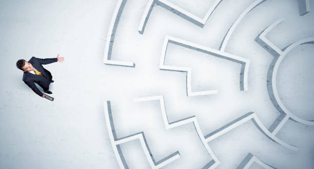 istock Business man looking at circular maze with nowhere to go 936284098