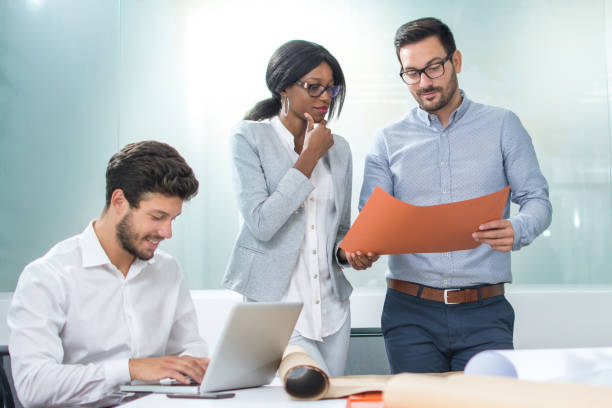 istock Business people and architects collaborating on business project 936286260