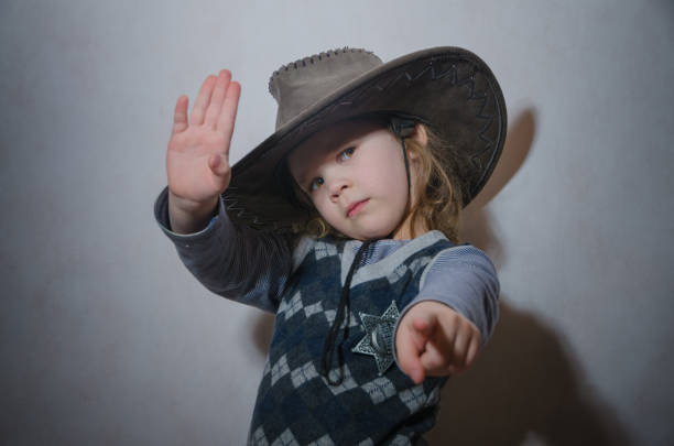 istock baby in cowboy hat and star, Sheriff badge 936292744