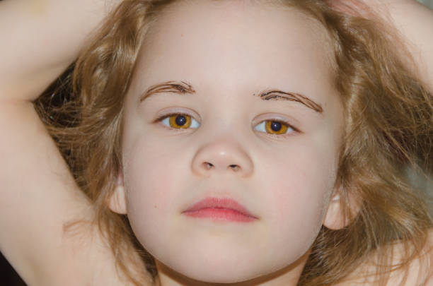 istock baby girl with eyebrow paint 936294374