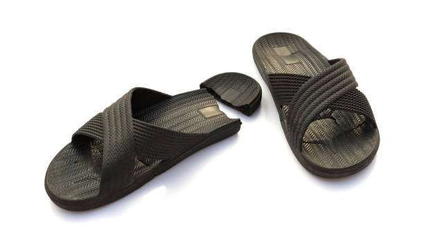 istock pair of badly worn out slippers on white 936295568