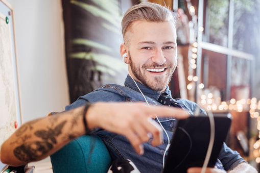 Young man is listening music at home