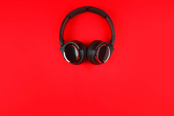 istock Black headphones on the red background. Music concept. 936301110