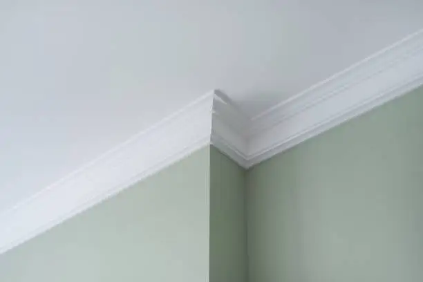 Photo of Ceiling moldings in the interior, detail of intricate corner.