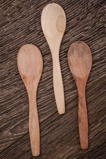Wooden spoons on brown wooden background