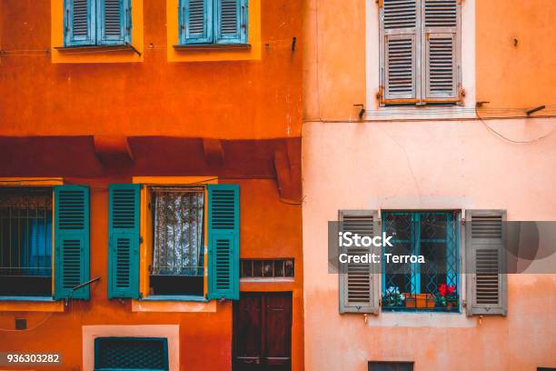 Ancient Facade In Orange And Rose Colors With Green Windows Stock Photo - Download Image Now