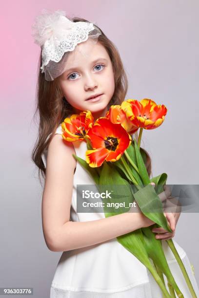 Girl With Big Blue Anime Eyes And A Bouquet Of Tulip Flowers In Her Hands  World Mothers Day Spring Day Spring Bouquet In The Hands Of The Child Long  Curly Blond Hair