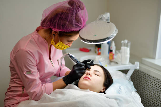 istock master does the tattoo on eyebrows to girl 936305080