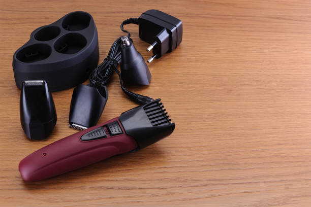 istock Stylish Electrical Hair Barber Clippers, Haircut accessories on wood background with copy space 936305708