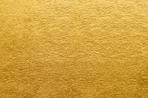 Gold foil texture. Golden abstract background close-up