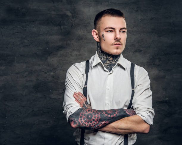istock A man with a tattoo on his face and arms. 936308744