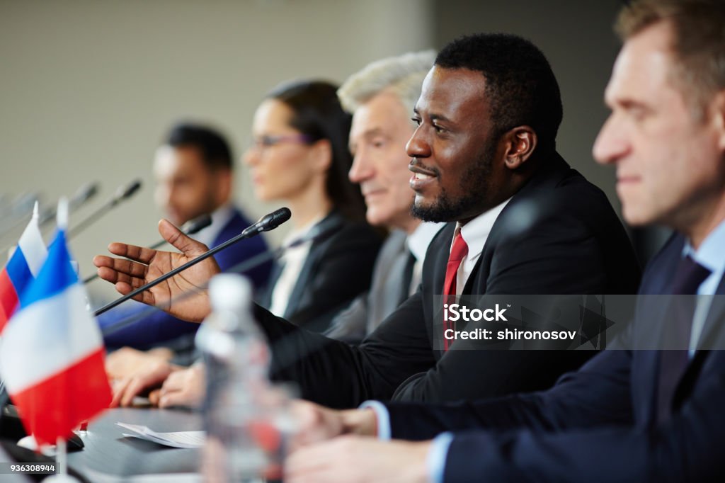 Delegates at conference Young African-american politician explaining his opinion to audience during conference Government Stock Photo