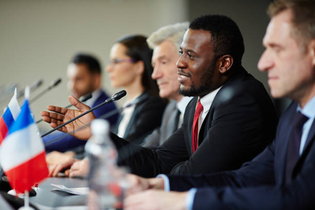 Delegates at conference Young African-american politician explaining his opinion to audience during conference summit meeting stock pictures, royalty-free photos & images