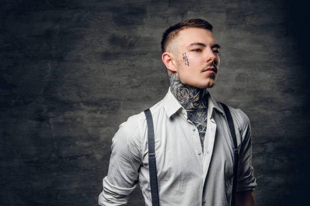 istock A man with a tattoo on his face and arms. 936310350